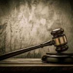 Judges gavel on a dark wooden surface.