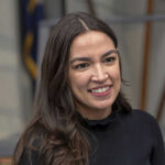 AOC’s Taiwan Stance Muddled by CNN’s Trump Angle A person smiling, wearing a black shirt.