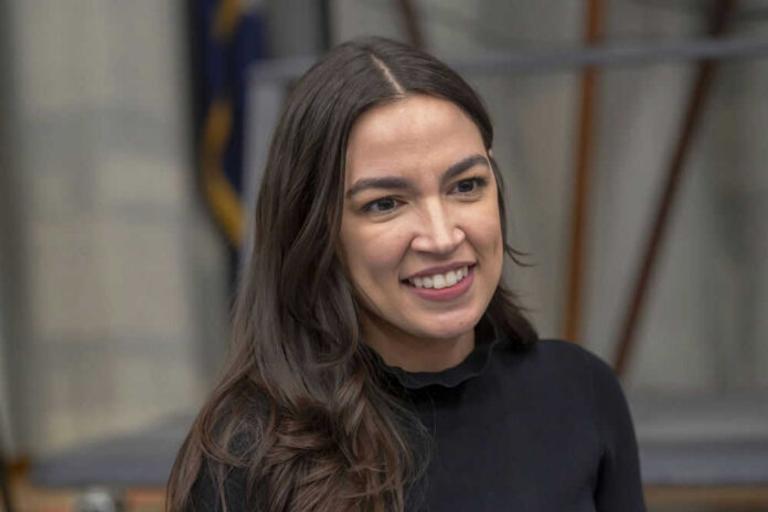 A person smiling, wearing a black shirt.