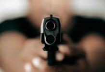 Gun barrel pointed directly at the camera