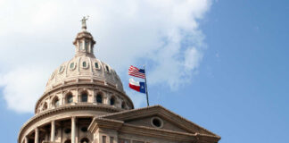 Texas State Capitol dome with American Texas flags