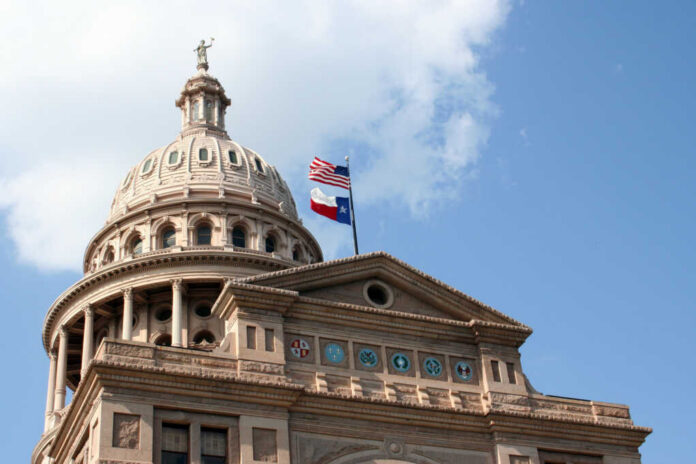 Texas State Capitol dome with American Texas flags