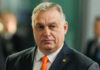 Hungary SLAMS Brakes on EU’s Ukraine Billions Man wearing suit with orange tie indoors