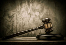 Judges gavel on a dark wooden surface.