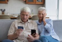 old couple with mobile phone and credit card