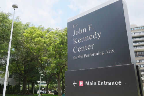 John F Kennedy Center sign near trees and buildings