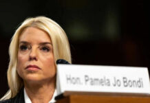 Woman sitting behind nameplate at conference or meeting