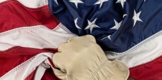 A gloved hand gripping an American flag