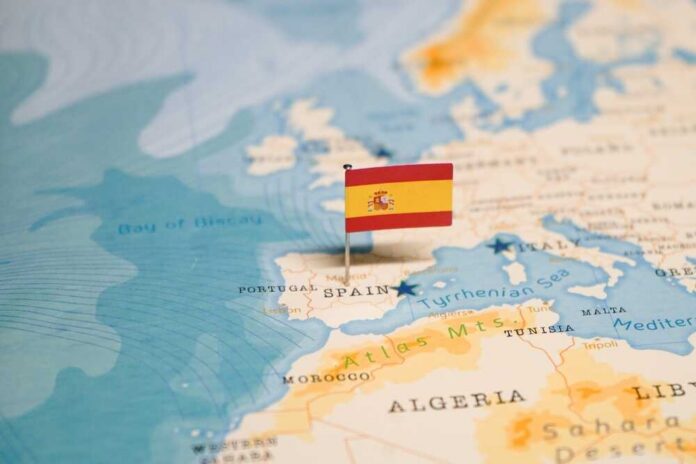 shutterstock_2324819391.jpg Map highlighting Spain with a small flag