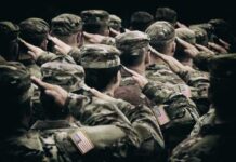 Rising Tensions: Saudi Base Hit, U.S. Casualties Climb Group of soldiers in uniform saluting during a ceremony