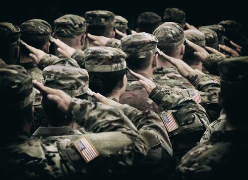 Group of soldiers in uniform saluting during a ceremony