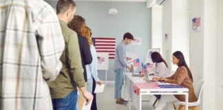 People waiting in line at a polling station to cast their votes