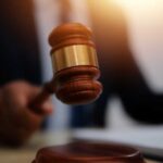 French Elite’s Dark Secret: Murder Network? A gavel being struck on a desk in a courtroom setting