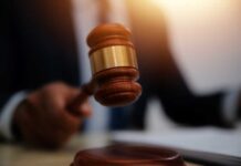 French Elite’s Dark Secret: Murder Network? A gavel being struck on a desk in a courtroom setting