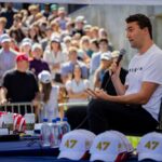 A speaker engaging with a crowd at an outdoor event