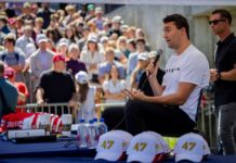 A speaker engaging with a crowd at an outdoor event
