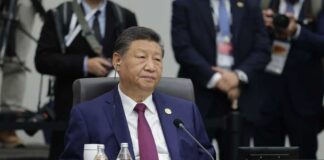 A leader seated at a conference table during an international summit