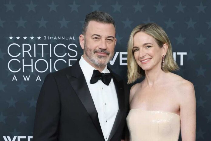 A couple posing together on the red carpet at an awards ceremony