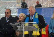 Ontario Premier Praises Homeowner After Intruder Shooting Politician speaking at a rally with supporters in winter attire