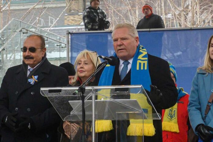 Politician speaking at a rally with supporters in winter attire