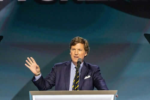 Person speaking at a podium with microphone