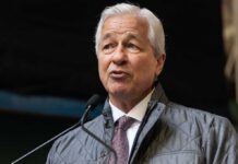 Business leader speaking at a conference wearing a quilted jacket