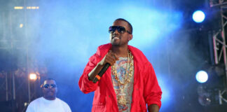 Two performers on stage with microphones and lights