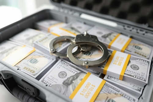 Briefcase with handcuffs and stacks of US dollars