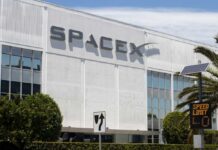 Exterior view of the SpaceX headquarters building with a speed limit sign