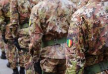 Soldiers in camouflage uniforms standing in formation