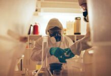 Scientists in protective gear conducting an experiment in a laboratory