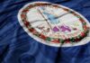 Virginia state flag with a blue background and money texture