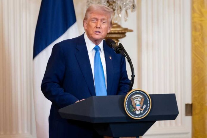 Donald Trump delivering a speech at a podium in the White House