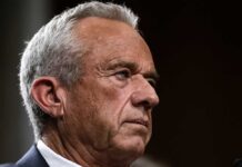Close-up portrait of a serious-looking man with gray hair
