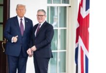 Two political leaders posing for a photo outside a building