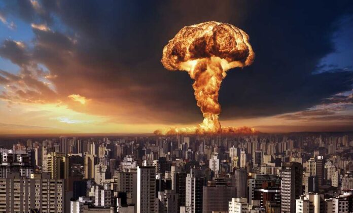 A large mushroom cloud rising over a city skyline at sunset