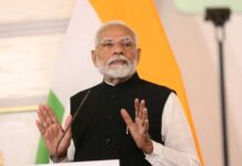 A political leader delivering a speech with hand gestures