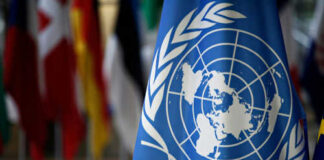 United Nations flag with other flags in background