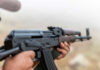 Terrifying TV Shift—Iran Broadcasting Rifle Training Person holding a rifle outdoors
