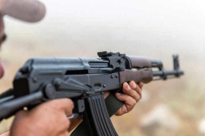 ak-472205580001jpg Person holding a rifle outdoors