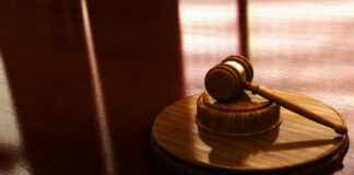 Gavel on a wooden table in sunlight