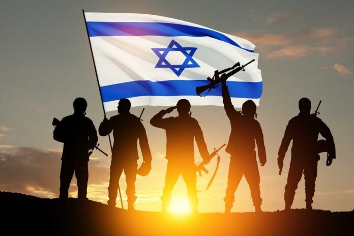 Silhouetted soldiers with rifles stand before an Israeli flag at sunset
