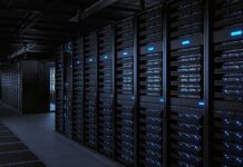 Rows of server racks illuminated in a dark data center