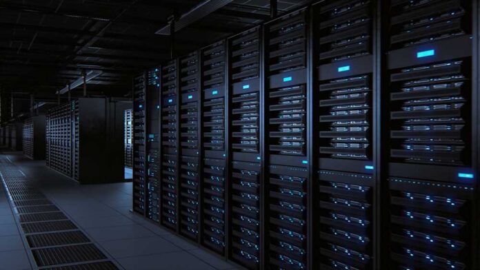 Rows of server racks illuminated in a dark data center