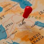 A map of the Middle East with a red pin marking Iraq
