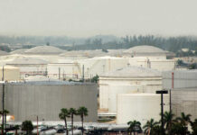 A view of large industrial fuel storage tanks in an urban area
