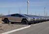 Row of Tesla Cybertrucks parked in a lot