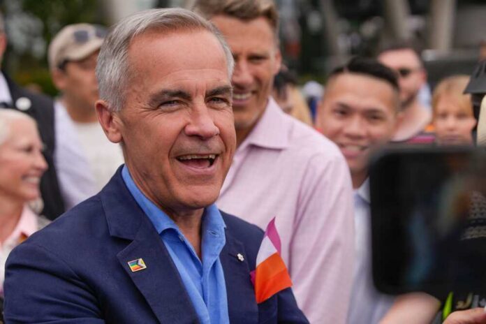 A smiling man engaging with a crowd at an outdoor event