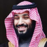 A man in traditional Saudi attire smiling at the camera