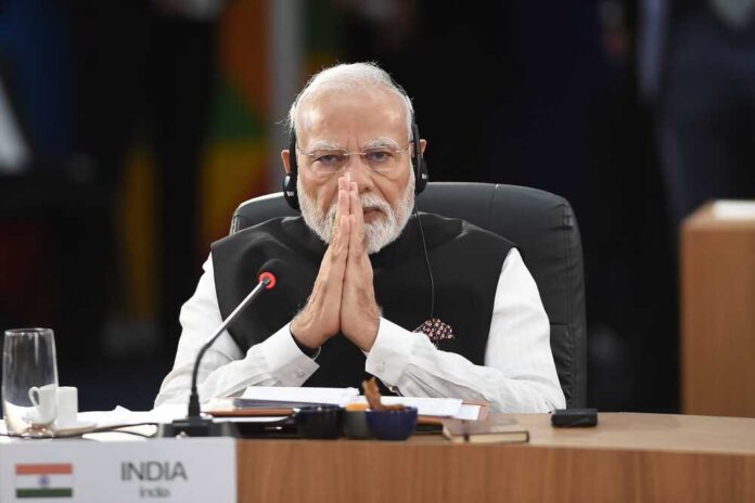 A leader with folded hands sitting at a conference table